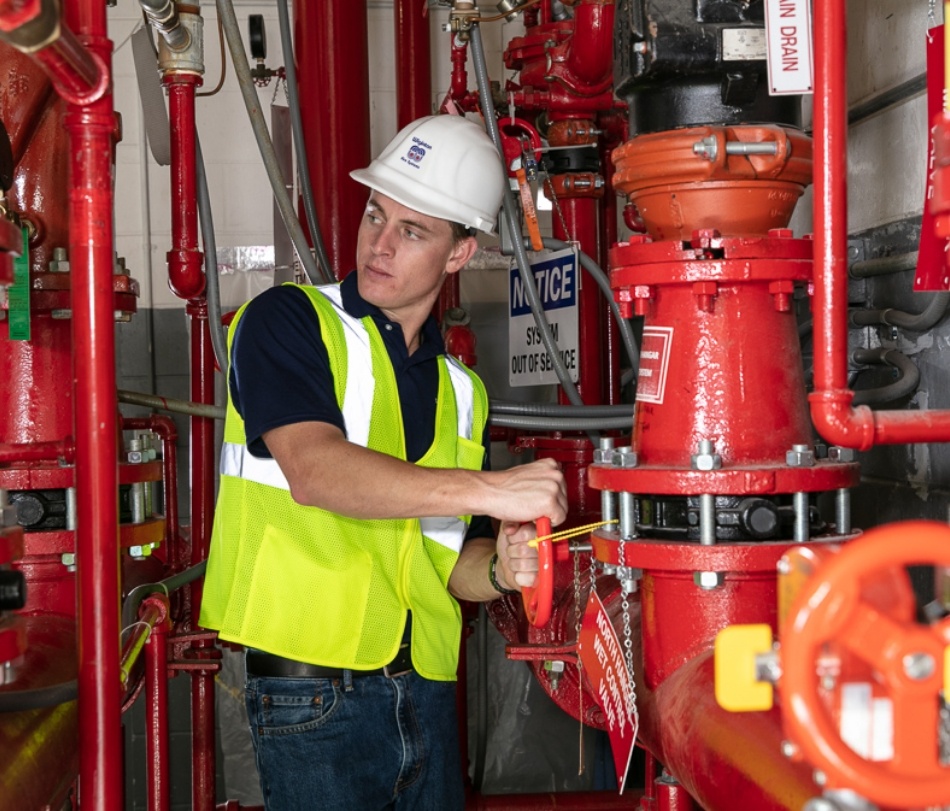 wiginton worker inspecting pipes