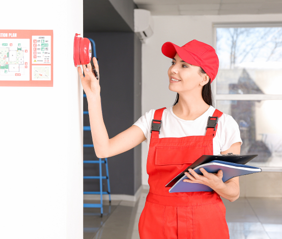 Inspector Reviewing Smoke Alarm for Regular Maintenance