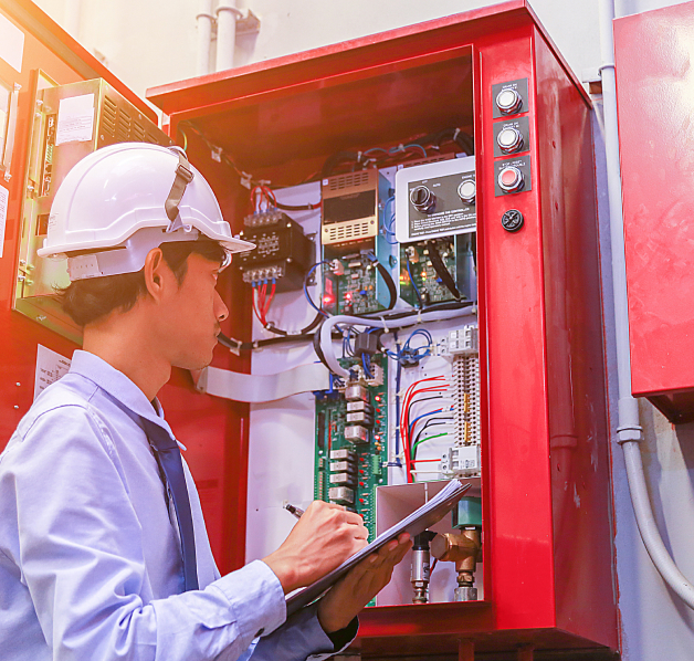 Inspector Reviewing Internals of Electronics Panel